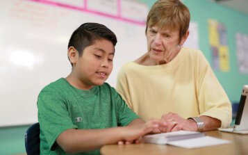 Lynne Zolli working with a student